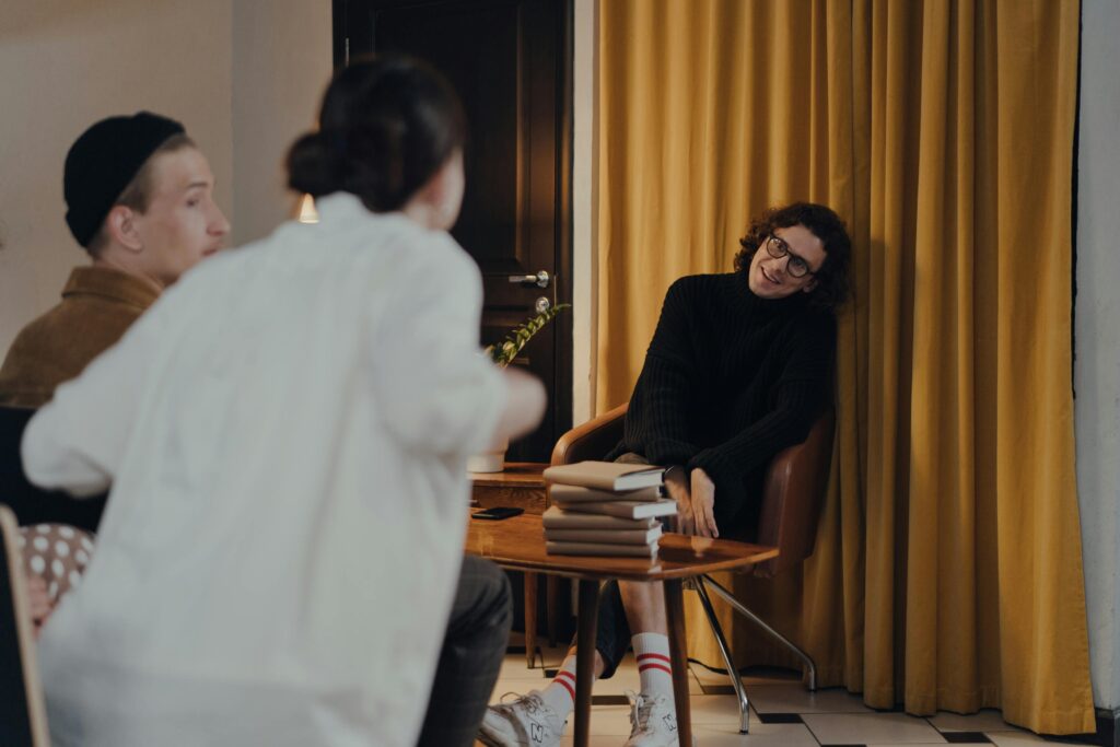 Author shares insights during an intimate book discussion indoors, fostering a creative exchange with attendees.